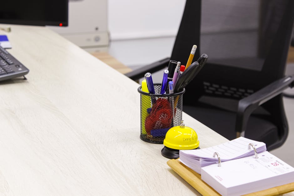 Tidy office desk with pen holder and clipboard, creating a clean workspace.